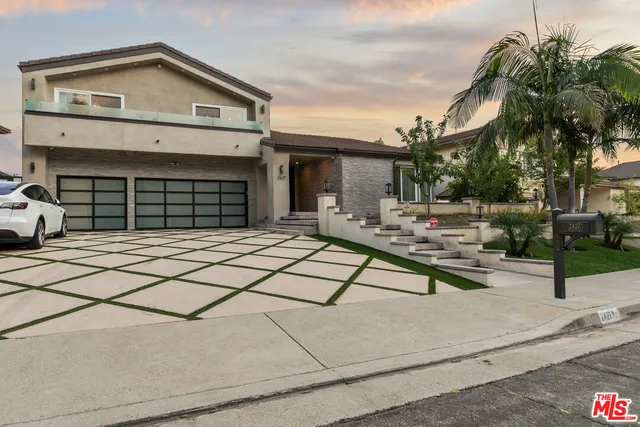 a view of a house with a patio and a yard