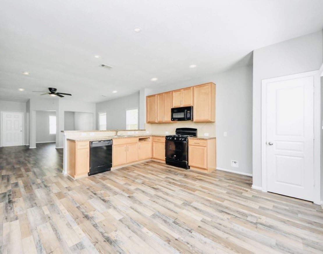 20414 Friesian Trail Humble, TX 77338 - Photo 5 of 6 a view of kitchen with stove top oven and cabinets