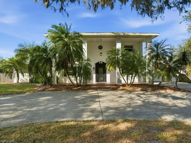 a view of a house with a yard and a garage