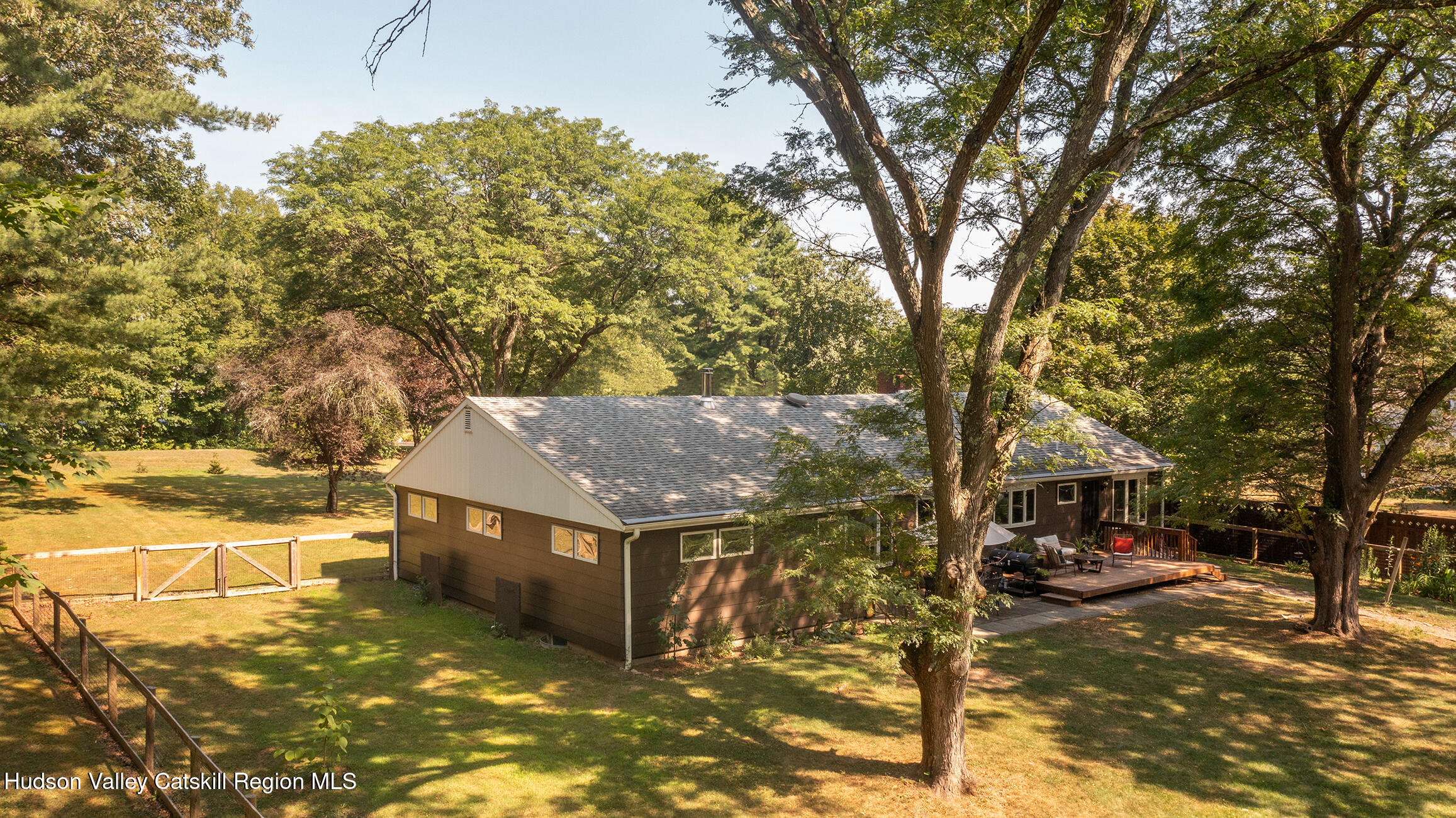 a view of a house with a tree in the background