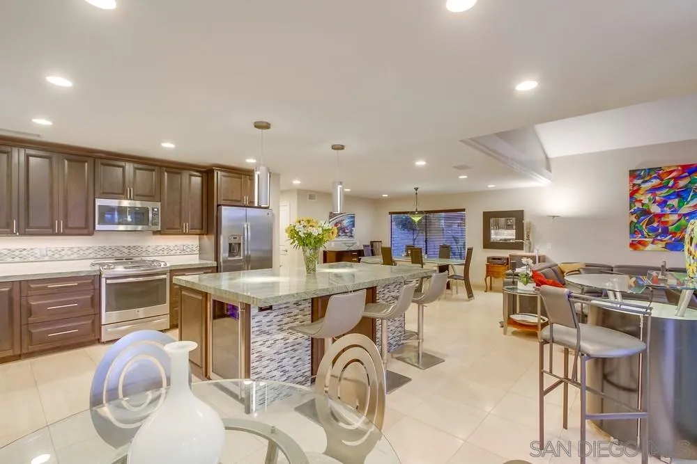 10 Sixpence Way Coronado, CA 92118 - Photo 14 of 23 a kitchen with stainless steel appliances kitchen island granite countertop a stove and white cabinets