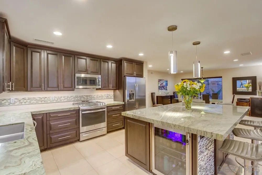 10 Sixpence Way Coronado, CA 92118 - Photo 16 of 23 a kitchen with kitchen island granite countertop a stove and a sink