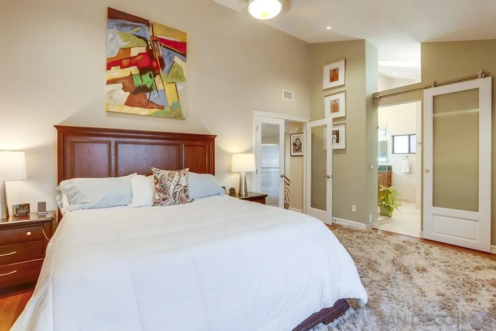 10 Sixpence Way Coronado, CA 92118 - Photo 19 of 23 a bedroom with a bed and painting on the wall