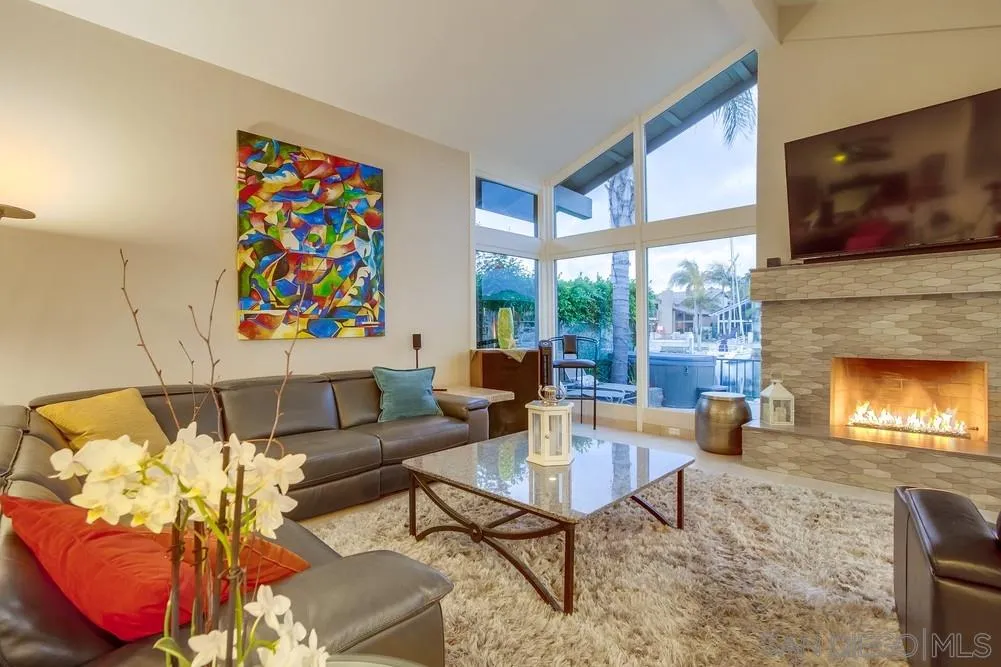 10 Sixpence Way Coronado, CA 92118 - Photo 9 of 23 a living room with furniture a flat screen tv and a fireplace