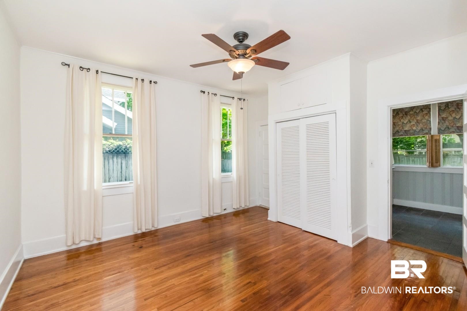 10 Macy Place Mobile, AL 36604 - Photo 20 of 43 Unfurnished bedroom with hardwood / wood-style flooring, a closet, and ceiling fan