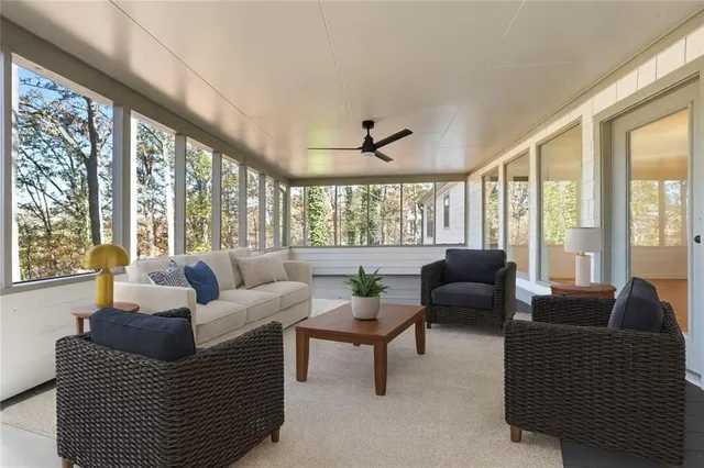 a view of a patio with couches chairs and wooden floor