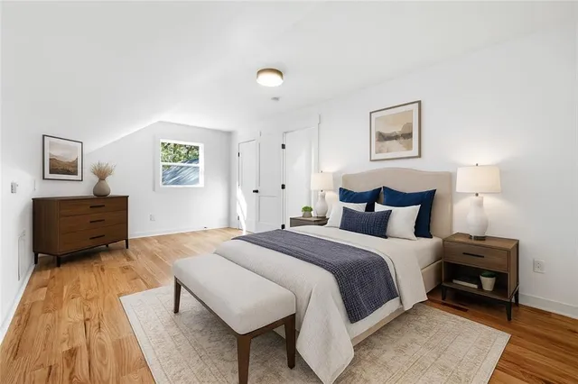 a bedroom with a large bed and a window