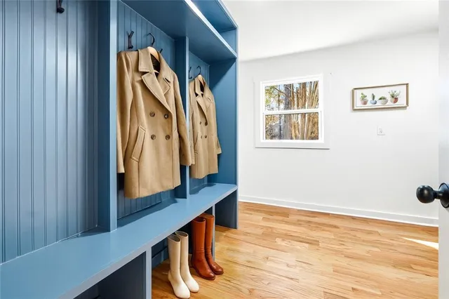 a view of a kitchen with a sink wooden cabinets and entryway