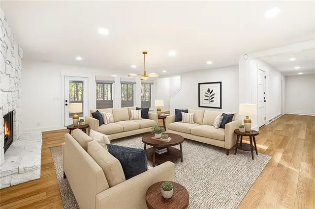 a living room with furniture flat screen tv and a large window
