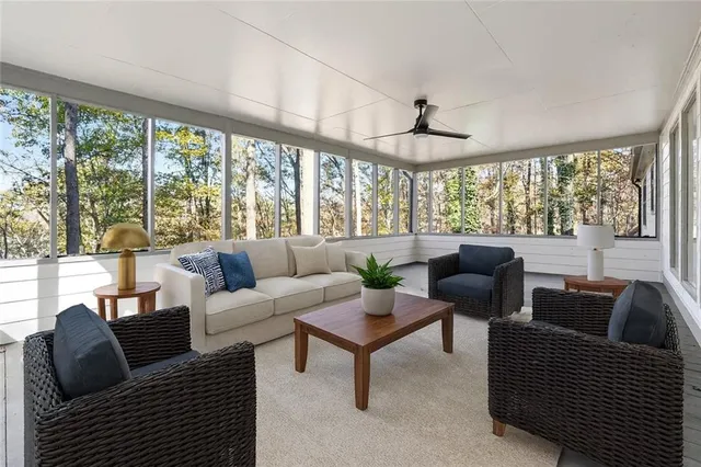 a roof deck with couches and wooden fence