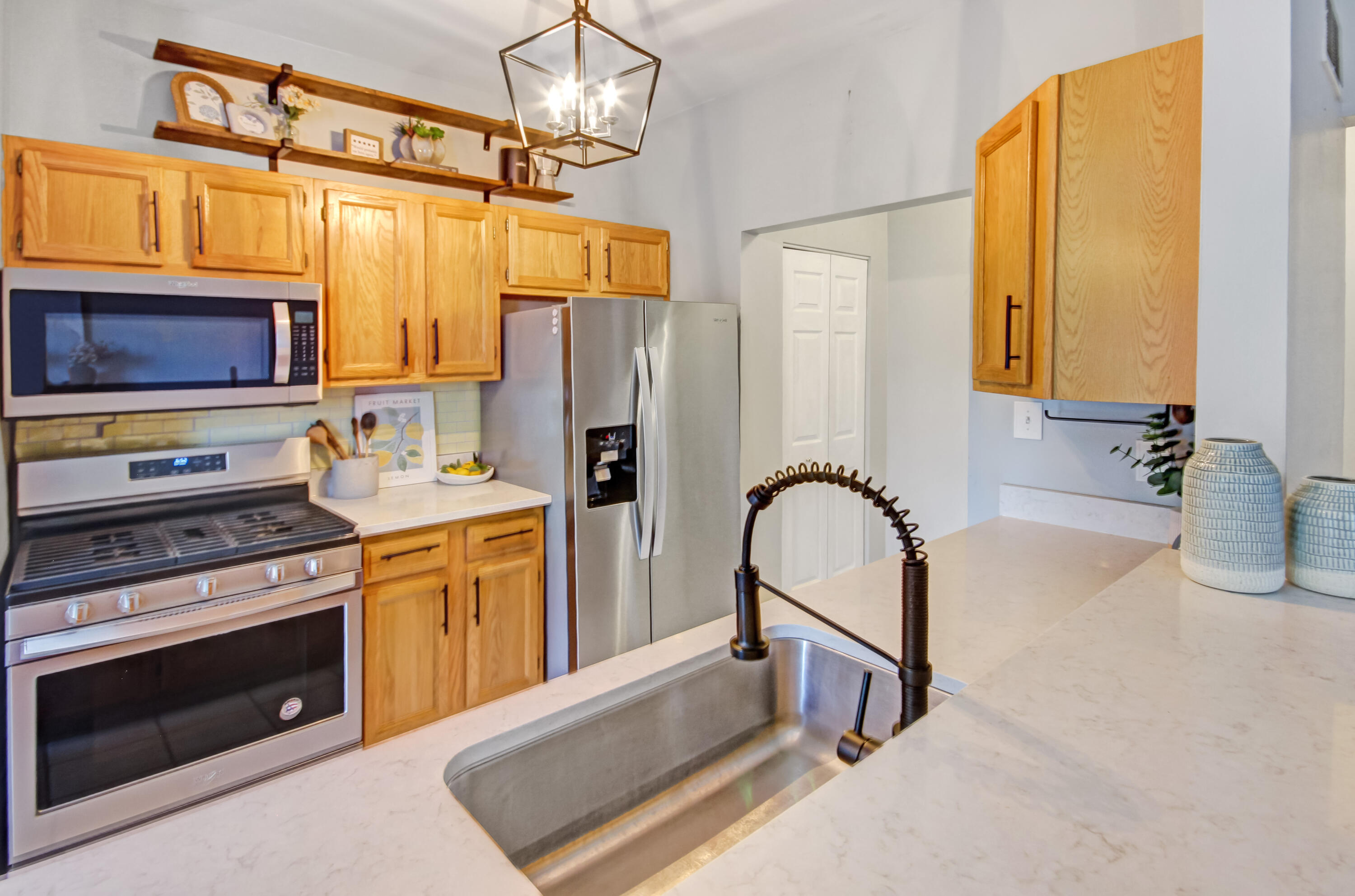 8109 Victoria Place Crown Point, IN 46307 - Photo 9 of 26 a kitchen with refrigerator a stove a sink and a microwave