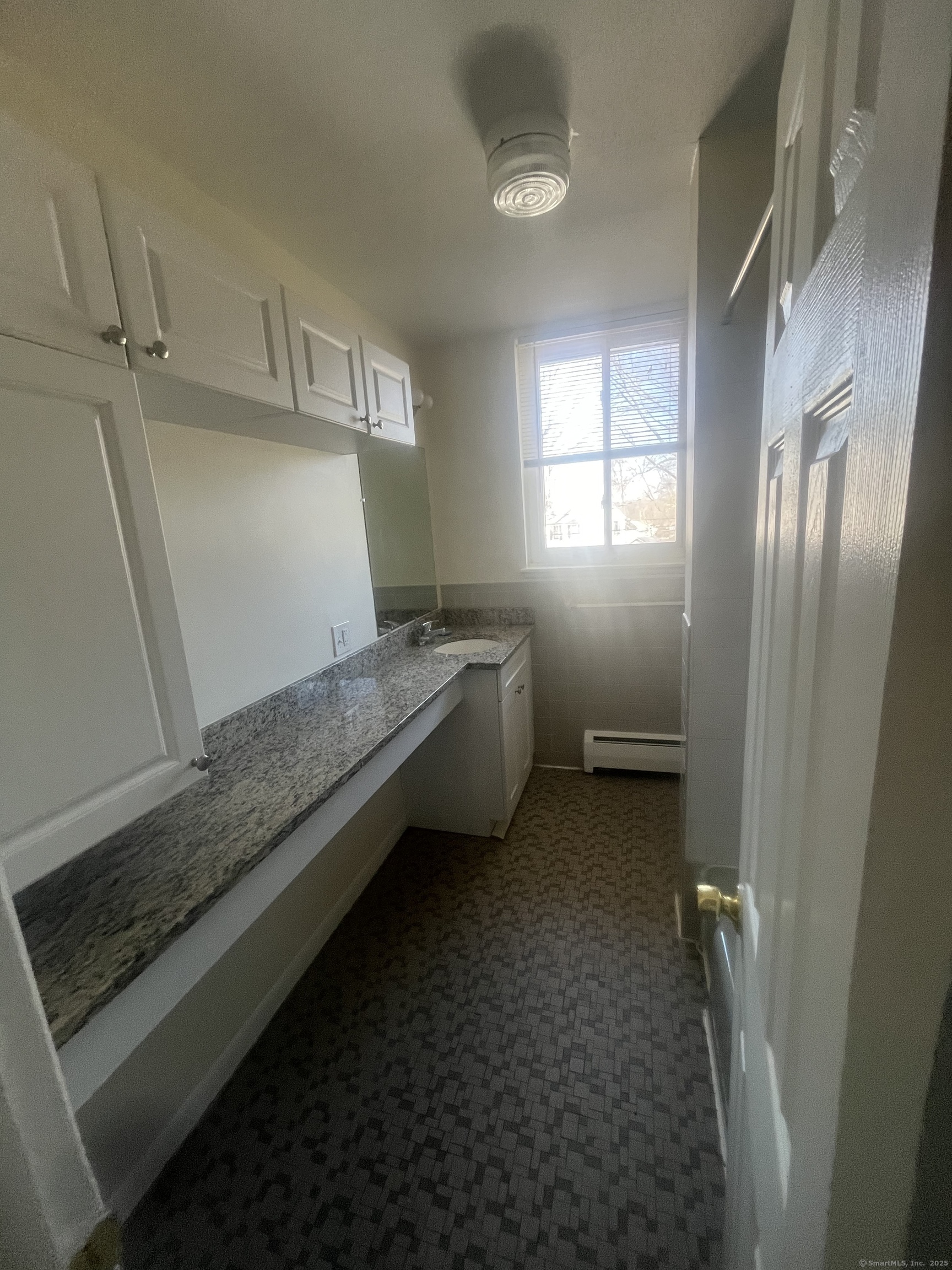 492 Fountain Street, Unit 504C2 New Haven, CT 06515 - Photo 11 of 20 a bathroom with a granite countertop sink and washing machine