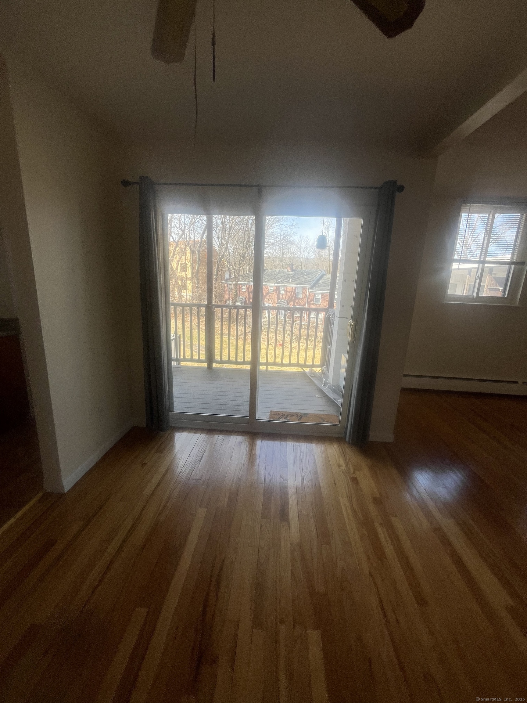 492 Fountain Street, Unit 504C2 New Haven, CT 06515 - Photo 18 of 20 an empty room with wooden floor and windows