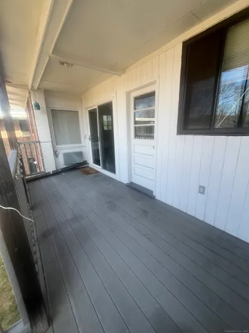 a view of a livingroom with wooden floor and stairs