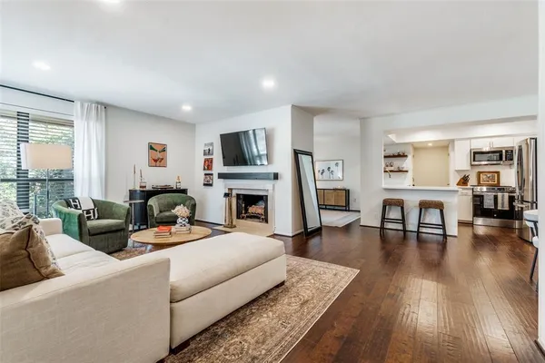 a living room with furniture fireplace and a flat screen tv