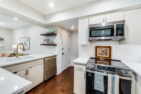 a kitchen with a stove and a microwave