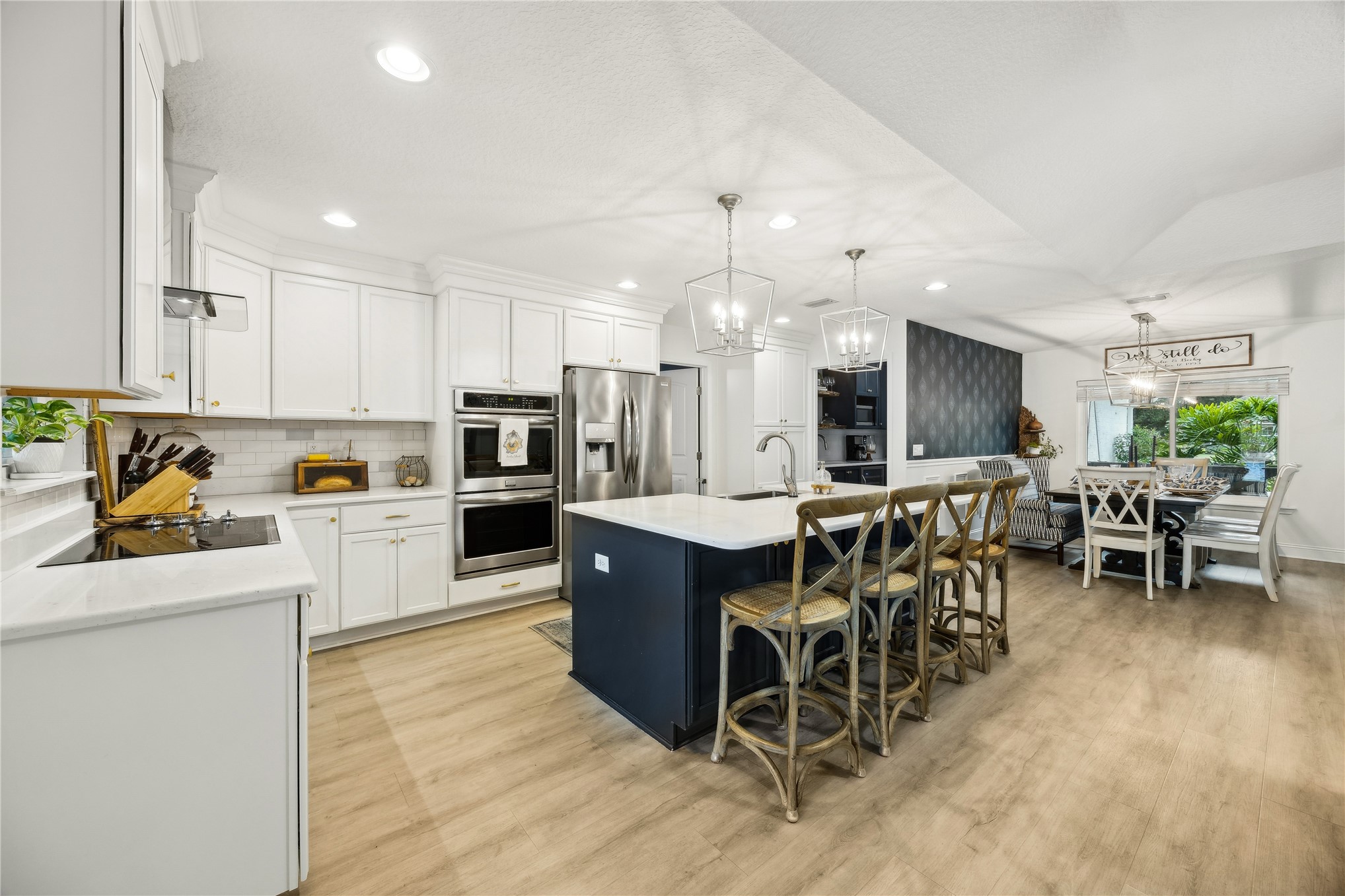 95103 Greenberry Road Fernandina Beach, FL 32034 - Photo 12 of 69 a kitchen with stainless steel appliances kitchen island granite countertop a table chairs sink and cabinets