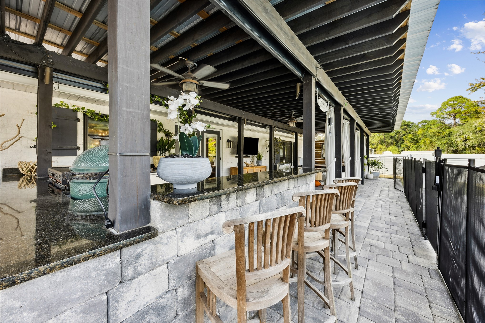 95103 Greenberry Road Fernandina Beach, FL 32034 - Photo 30 of 69 a view of a patio with table and chairs potted plants with wooden floor and fence