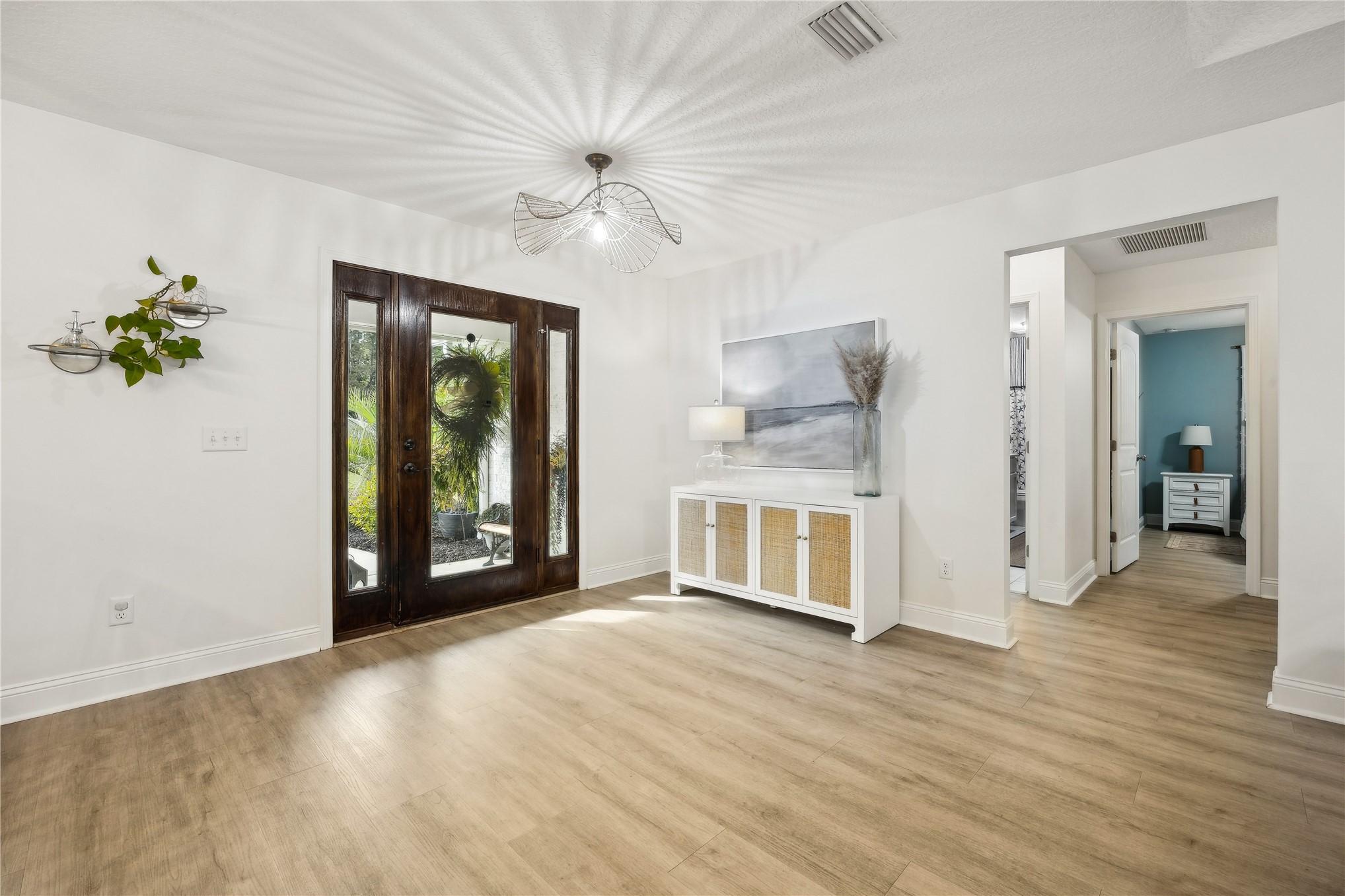 95103 Greenberry Road Fernandina Beach, FL 32034 - Photo 8 of 69 a view of an empty room with wooden floor and a window