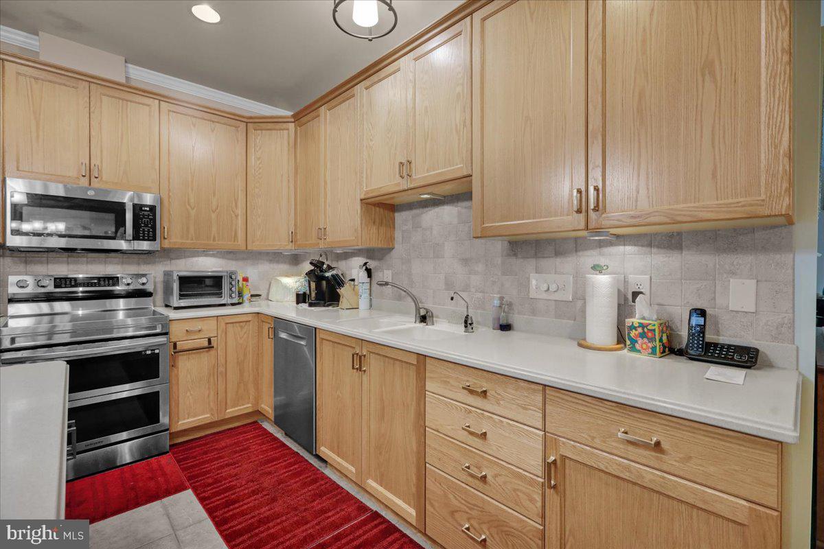55 Turning Leaf Way Reading, PA 19605 - Photo 16 of 37 a kitchen with cabinets stainless steel appliances and a sink