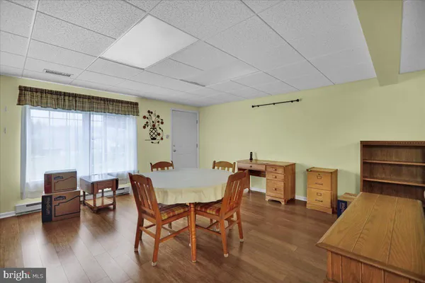 a dining room with furniture and wooden floor