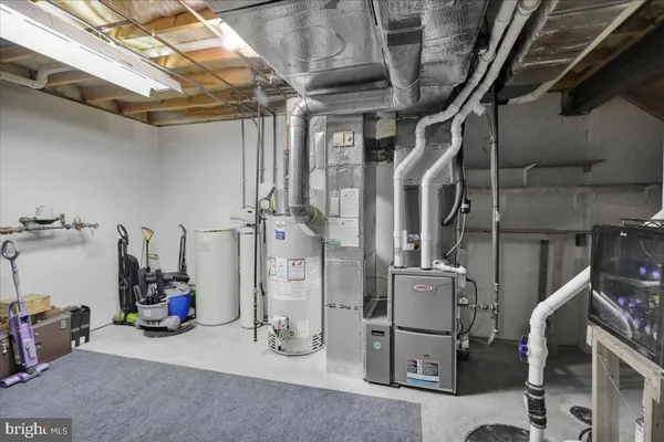 a view of a storage room with water heater and racks