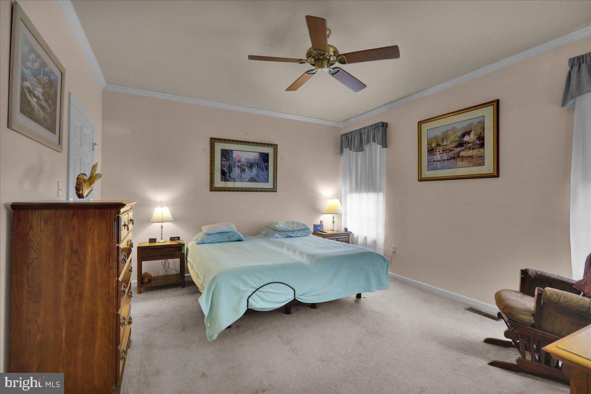 55 Turning Leaf Way Reading, PA 19605 - Photo 4 of 37 a bedroom with a bed and a chandelier