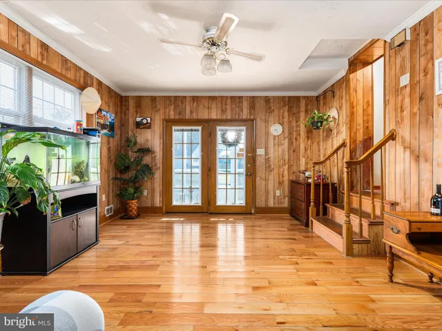 a view of an entryway with wooden floor and door