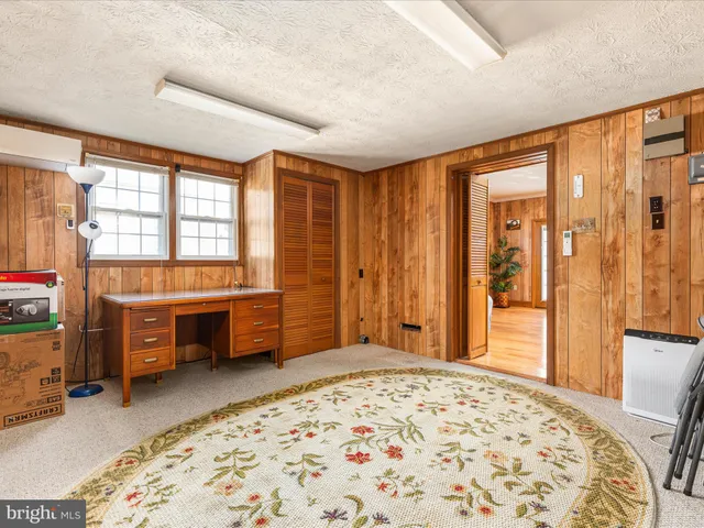 a bedroom with furniture and a window