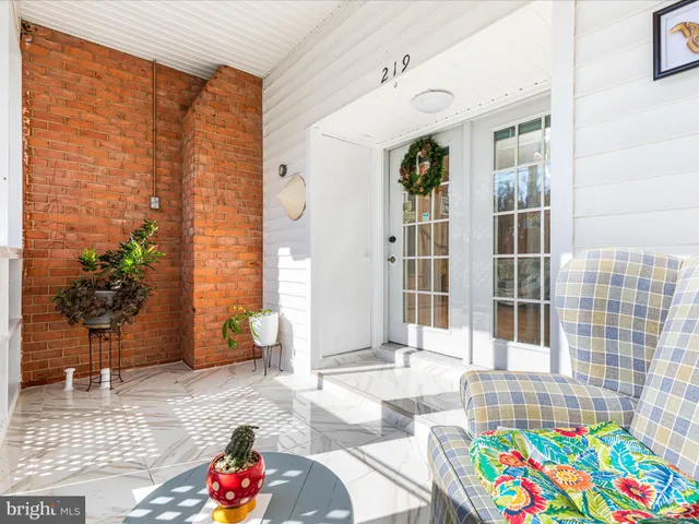 a front view of a house with outdoor seating