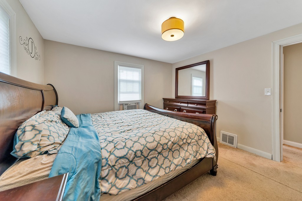48 Drexel Street Springfield, MA 01104 - Photo 10 of 24 a bedroom with a bed and painting on the wall