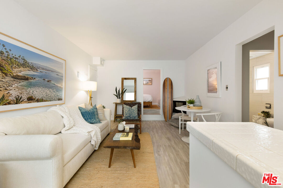 8155 Manitoba Street, Unit 12 Playa del Rey, CA 90293 - Photo 4 of 16 a living room with furniture a rug and white walls