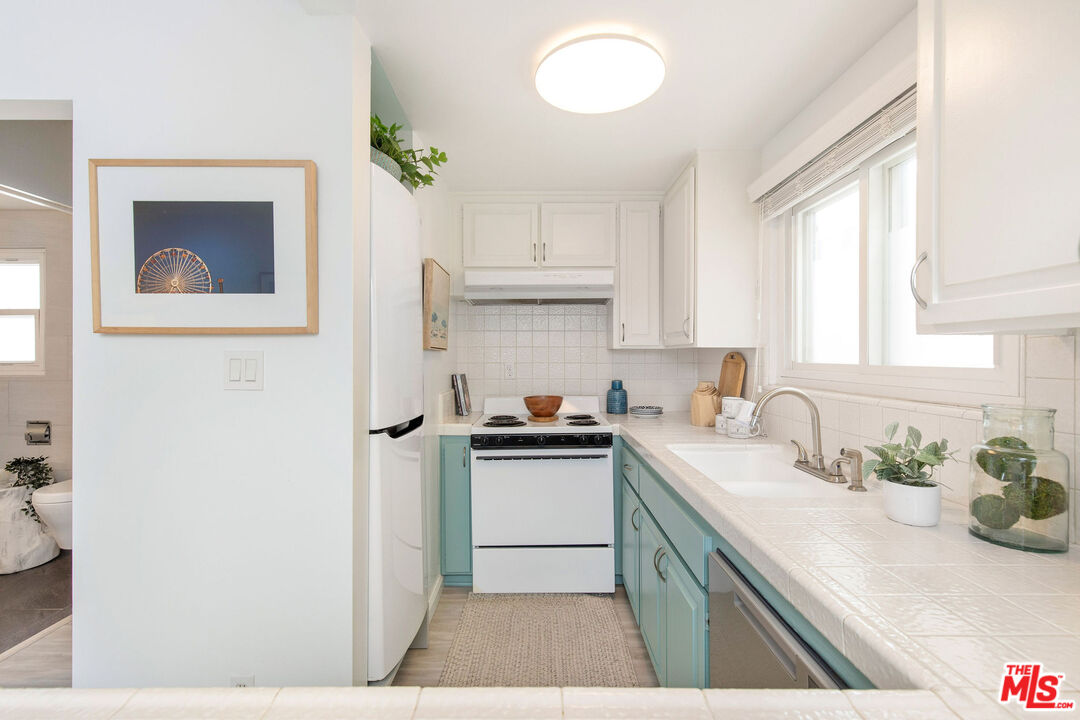 8155 Manitoba Street, Unit 12 Playa del Rey, CA 90293 - Photo 6 of 16 a kitchen with a sink cabinets and window