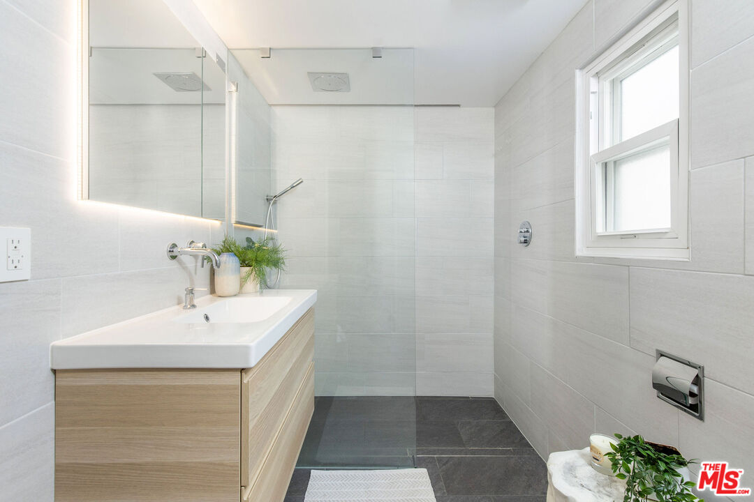 8155 Manitoba Street, Unit 12 Playa del Rey, CA 90293 - Photo 7 of 16 a bathroom with a sink a vanity and a mirror