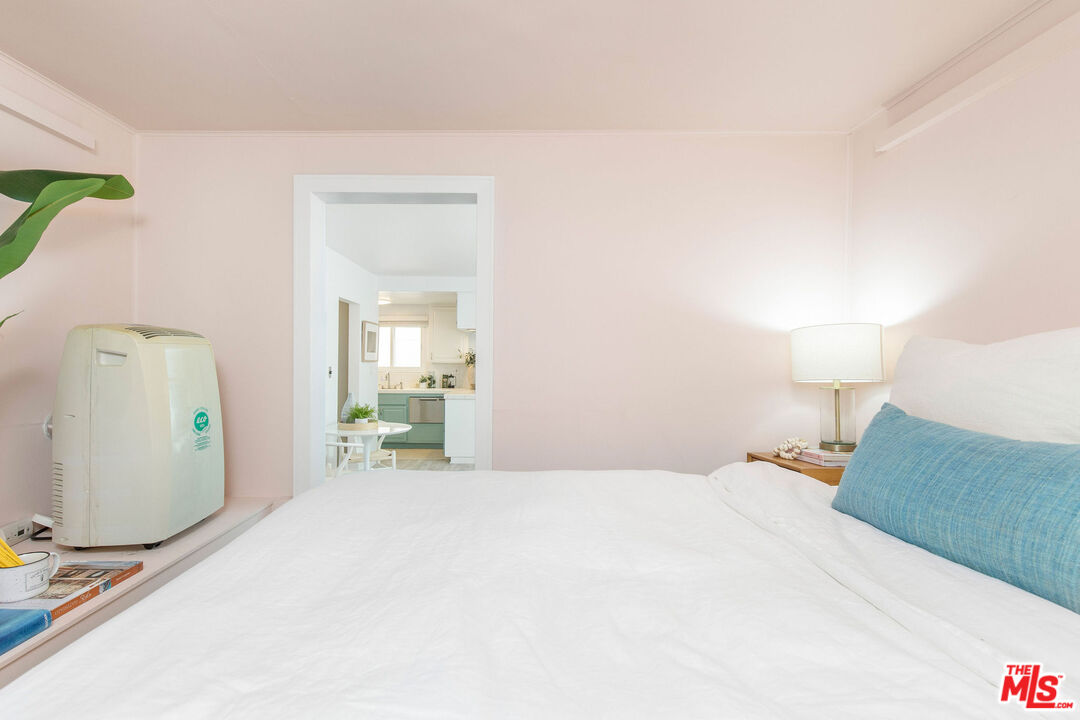 8155 Manitoba Street, Unit 12 Playa del Rey, CA 90293 - Photo 9 of 16 a bedroom with a bed and a lamp on table