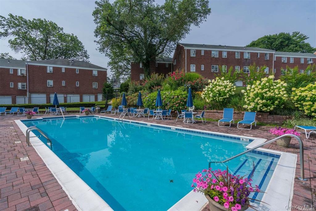 425 Main Street, Unit 92A Huntington, NY 11743 - Photo 12 of 13 a view of a swimming pool with a patio