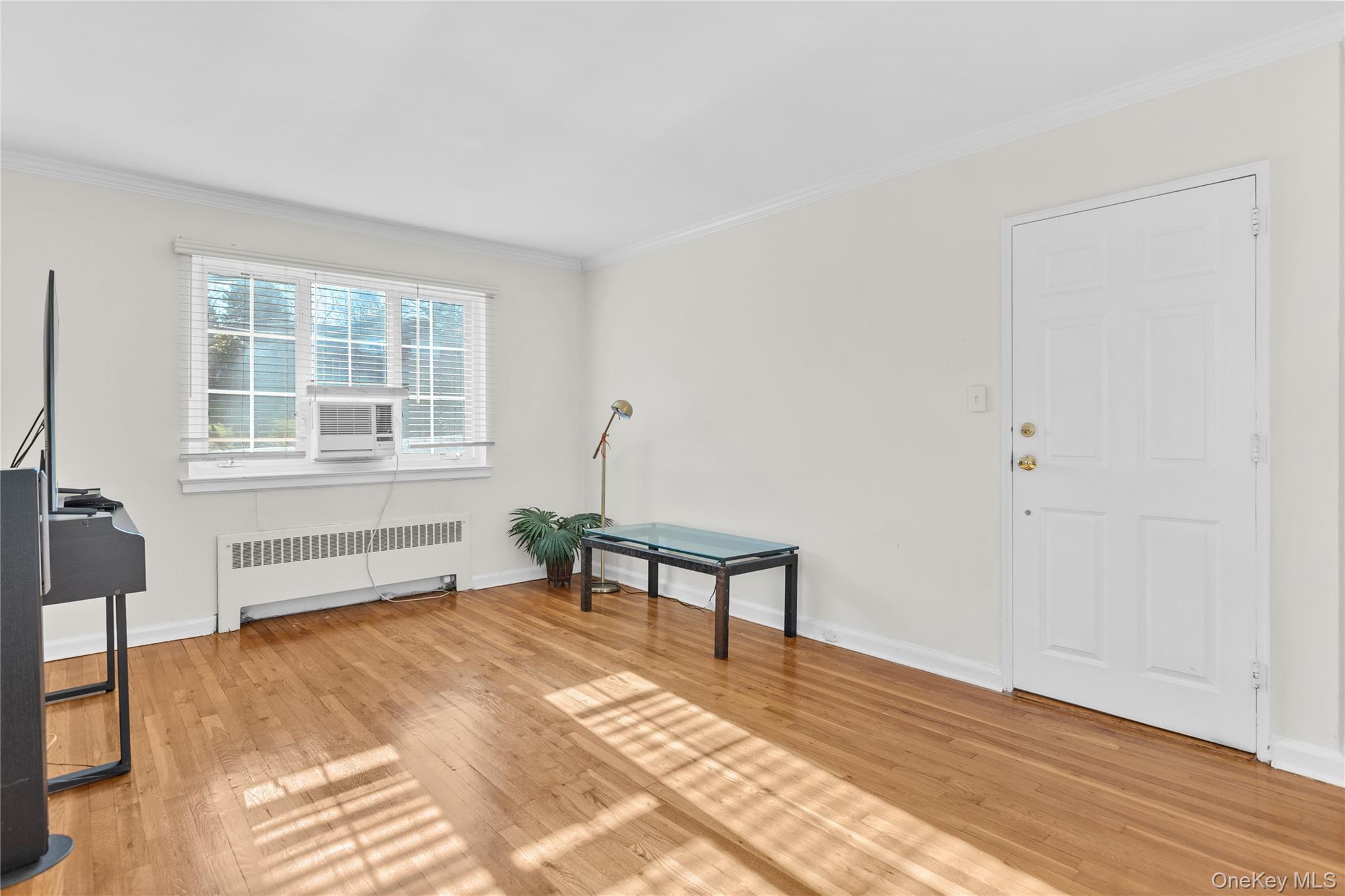 425 Main Street, Unit 92A Huntington, NY 11743 - Photo 4 of 13 a bedroom with a bed and a window