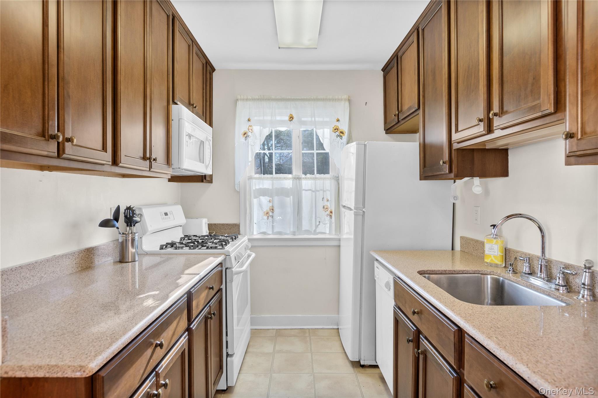 425 Main Street, Unit 92A Huntington, NY 11743 - Photo 7 of 13 a kitchen with stainless steel appliances granite countertop a sink stove and refrigerator