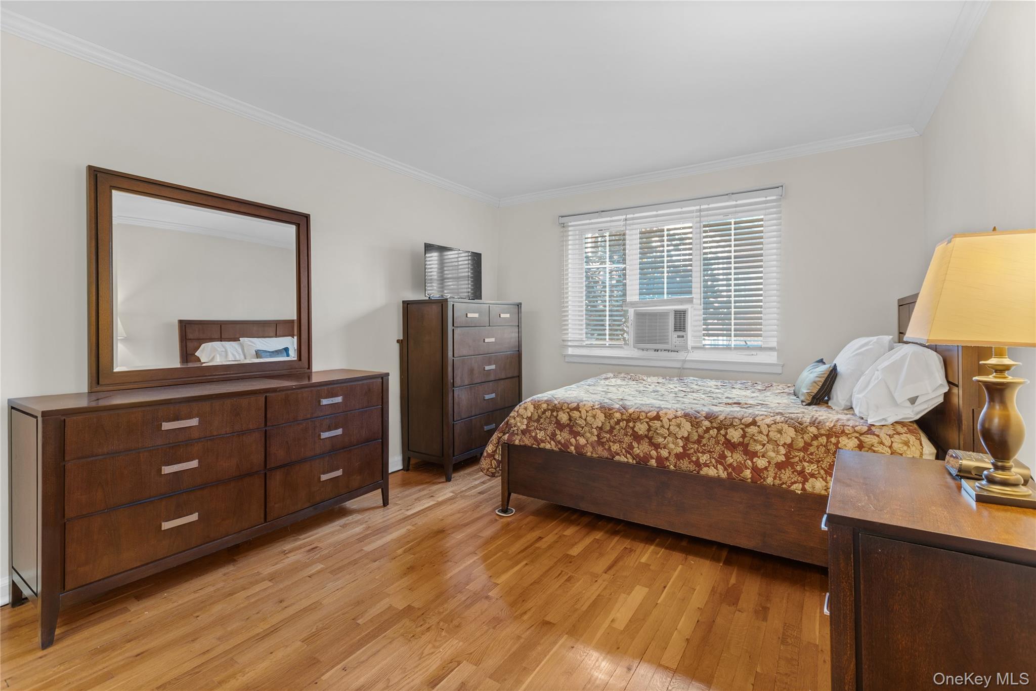425 Main Street, Unit 92A Huntington, NY 11743 - Photo 8 of 13 a bed room with a bed and a dresser