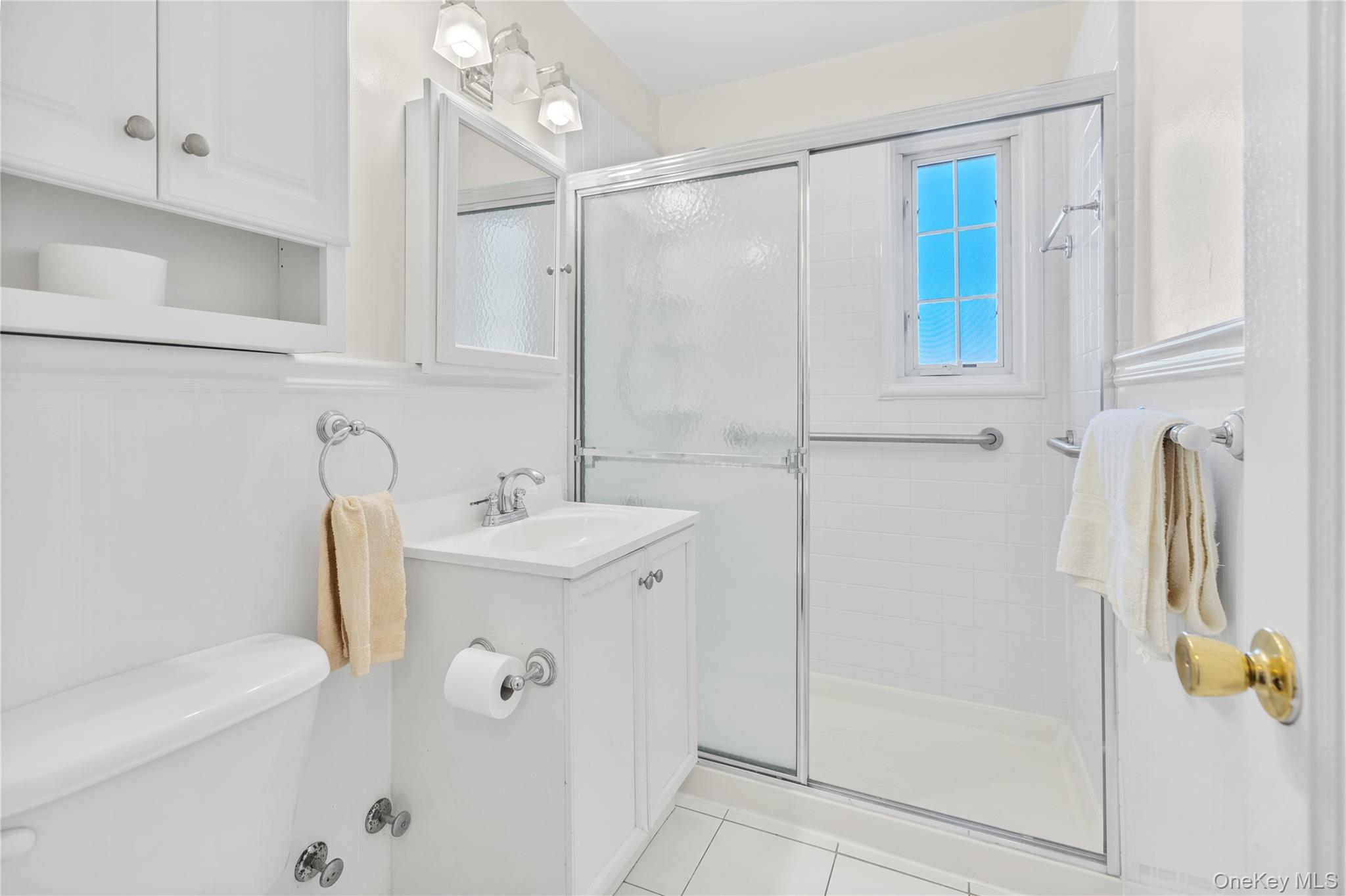 425 Main Street, Unit 92A Huntington, NY 11743 - Photo 10 of 13 a bathroom with a sink a mirror and shower