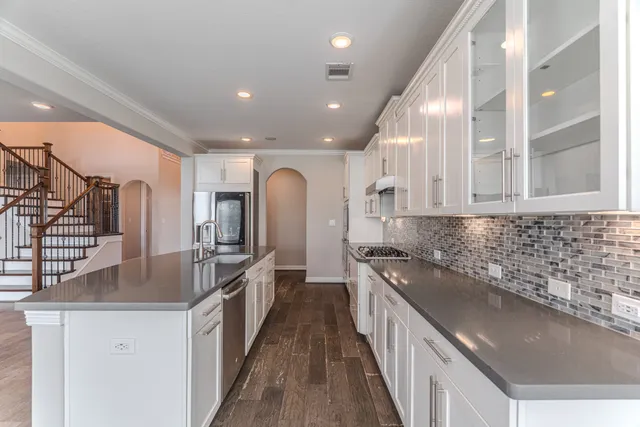 a kitchen with stainless steel appliances granite countertop a sink and stove