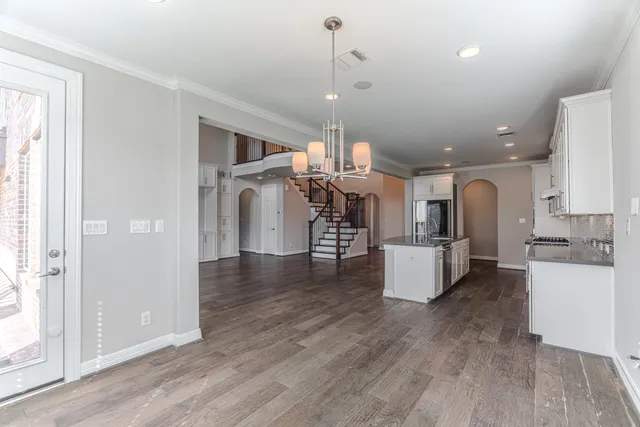 a living room with furniture and kitchen view