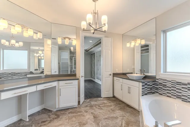 a bathroom with a granite countertop sink a toilet and a mirror