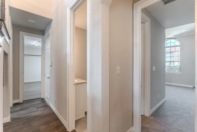 a view of a hallway with wooden floor