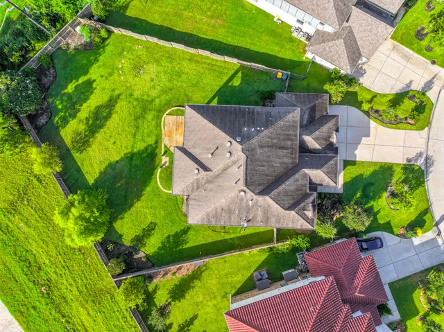 an aerial view of a house with garden space and street view