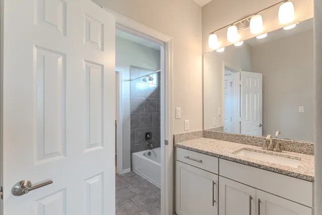 a view of an empty room with a ceiling fan