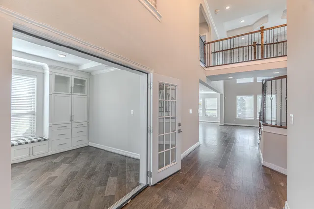wooden floor in a hall with a window and wooden floor