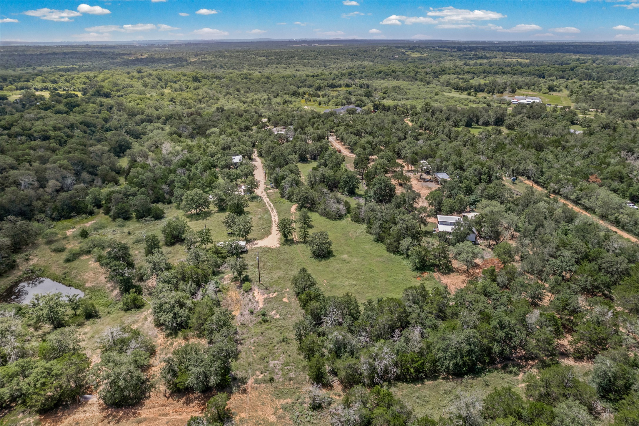 564 Boyd Road Red Rock, TX 78662 - Photo 6 of 25 Vast, verdant landscape offering serene, secluded living amidst rolling hills.