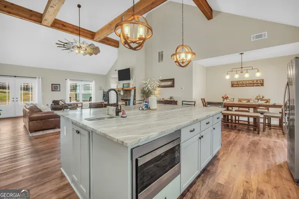a view of a dining room with furniture wooden floor and chandelier