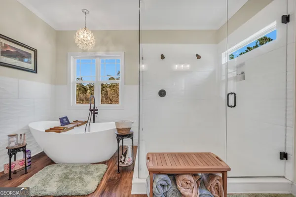 a bathroom with a double vanity sink a toilet a mirror and shower